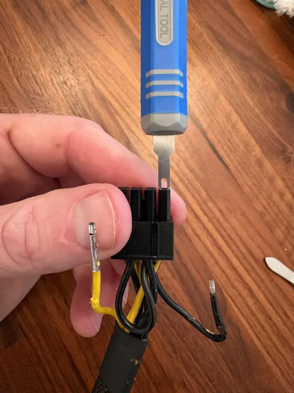 Re-pinning the GPU power cable with a pin-extraction tool