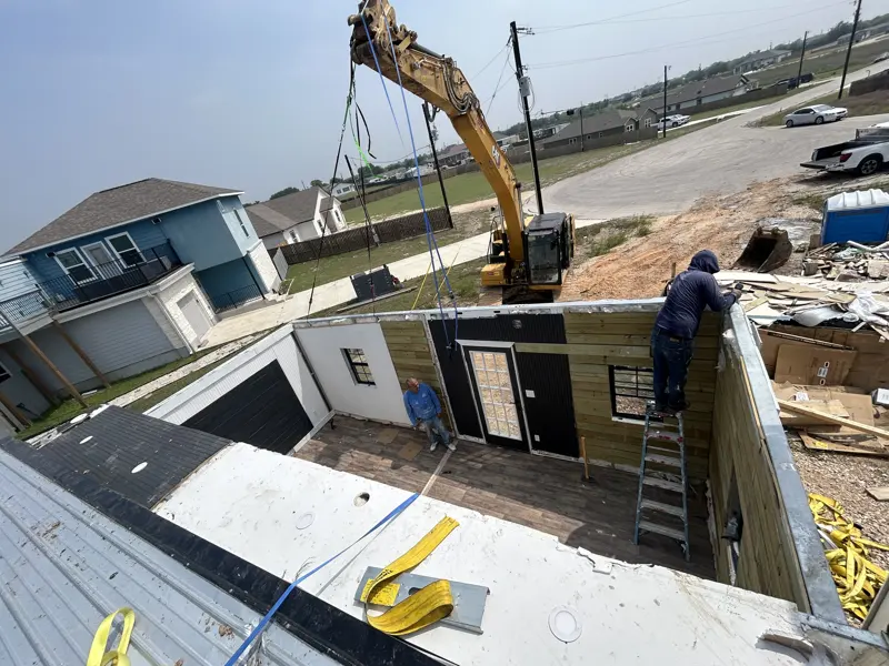 Excavator unfolding the module on site
